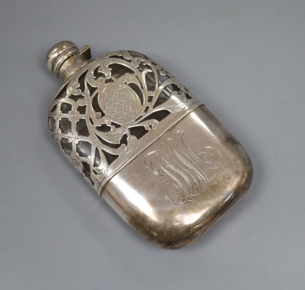 A white metal overlaid glass hip flask, with white metal cup and engraved monogram, 16.7cm.